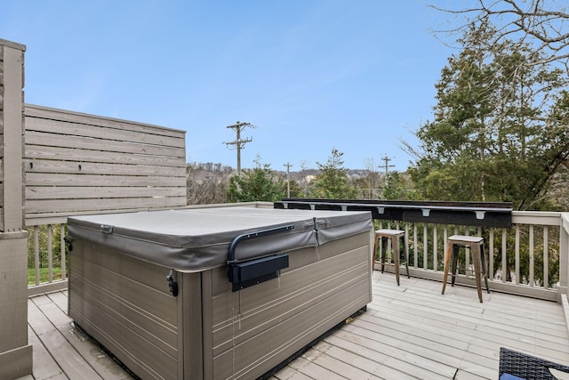 wooden terrace featuring a hot tub