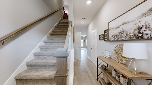 staircase featuring wood-type flooring