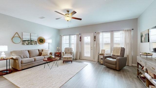 living room with ceiling fan and light hardwood / wood-style floors