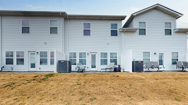 back of property featuring a lawn, central AC unit, and a patio area