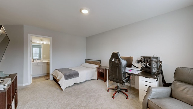 bedroom featuring light carpet and ensuite bath