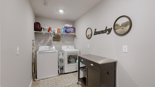 clothes washing area featuring separate washer and dryer