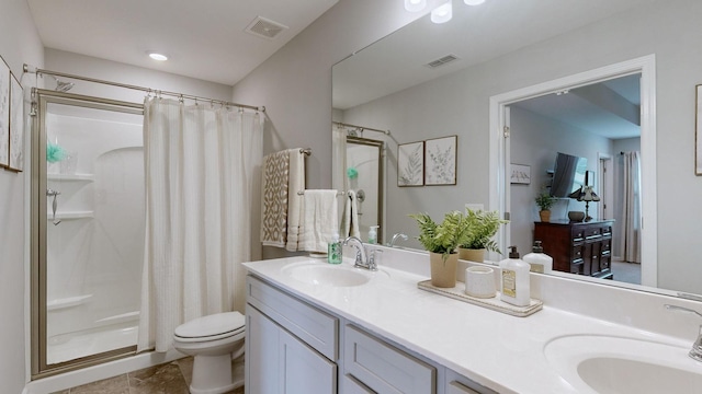 bathroom featuring vanity, toilet, and walk in shower