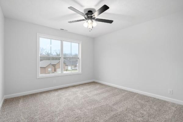 carpeted empty room with ceiling fan