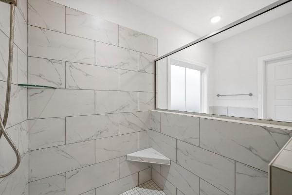 bathroom with tiled shower