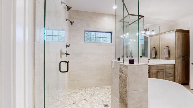 bathroom with vanity, ornamental molding, and independent shower and bath