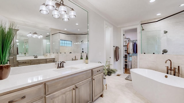 bathroom featuring plus walk in shower, vanity, and tile walls