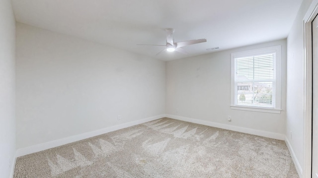 spare room featuring ceiling fan and light colored carpet