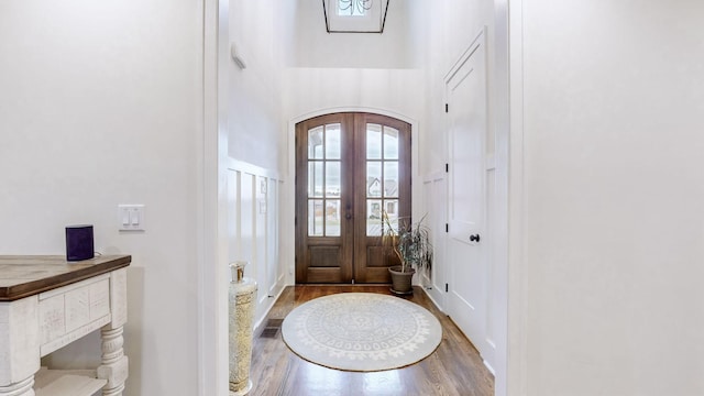 entryway with french doors and hardwood / wood-style flooring