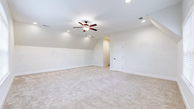 bonus room with ceiling fan, light colored carpet, and vaulted ceiling