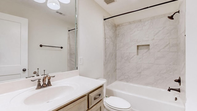 full bathroom with vanity, toilet, and tiled shower / bath combo