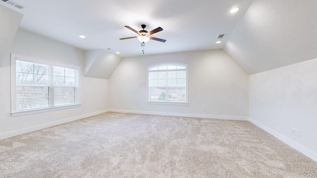 additional living space featuring ceiling fan, light colored carpet, and lofted ceiling