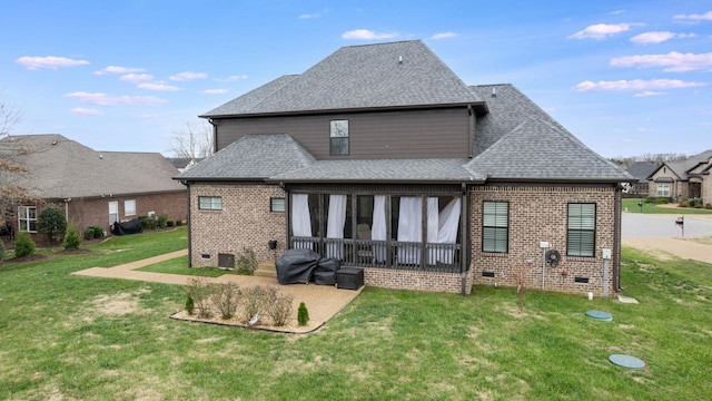 back of property with a lawn and a sunroom