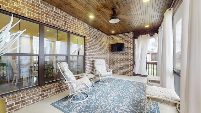 sunroom / solarium featuring ceiling fan and wooden ceiling