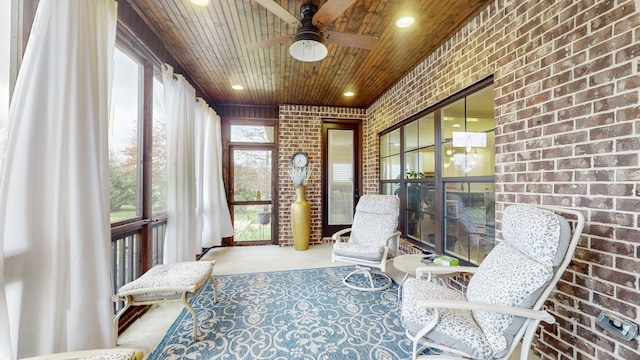 sunroom / solarium featuring ceiling fan and wood ceiling