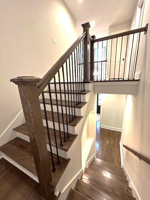 staircase featuring hardwood / wood-style flooring