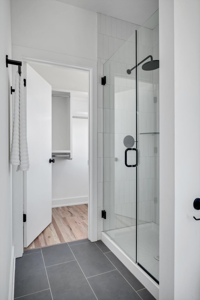 bathroom featuring tile patterned flooring and a shower with door