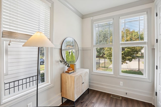 entryway with dark hardwood / wood-style flooring and ornamental molding