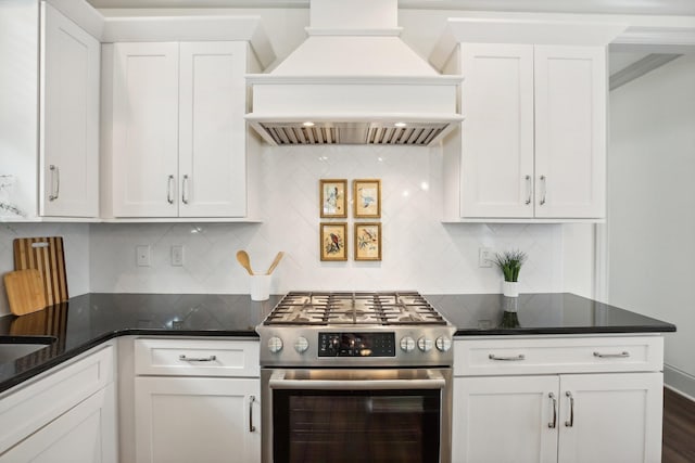 kitchen featuring white cabinetry, dark stone counters, decorative backsplash, high end stainless steel range, and custom exhaust hood