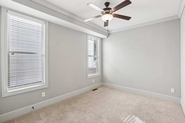 empty room with crown molding, ceiling fan, and light carpet