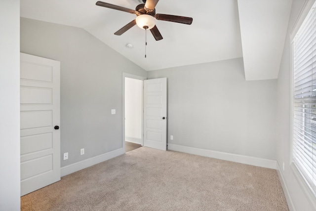 unfurnished bedroom with ceiling fan, light carpet, and vaulted ceiling