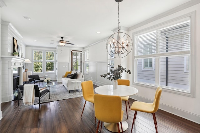 dining space with ceiling fan with notable chandelier, dark hardwood / wood-style floors, and ornamental molding