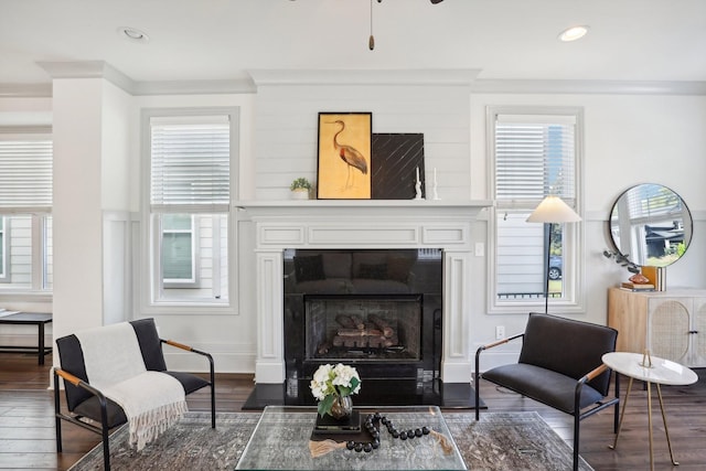 living room featuring crown molding, ceiling fan, and dark hardwood / wood-style floors