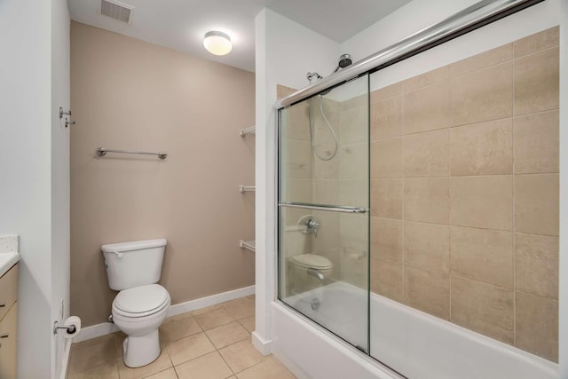 full bathroom featuring shower / bath combination with glass door, vanity, tile patterned floors, and toilet