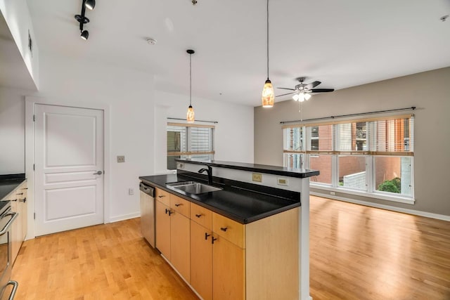 kitchen with light brown cabinets, track lighting, sink, ceiling fan, and stainless steel appliances