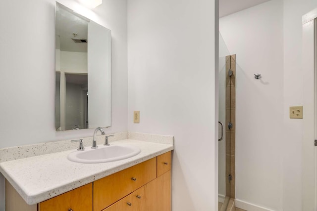 bathroom with vanity and an enclosed shower