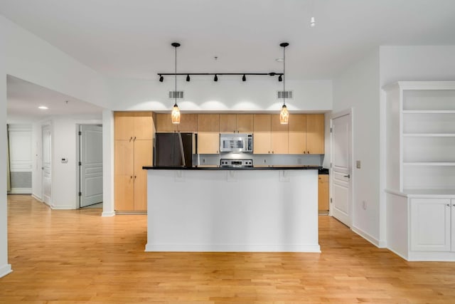 kitchen featuring light wood-type flooring, refrigerator, track lighting, decorative light fixtures, and range