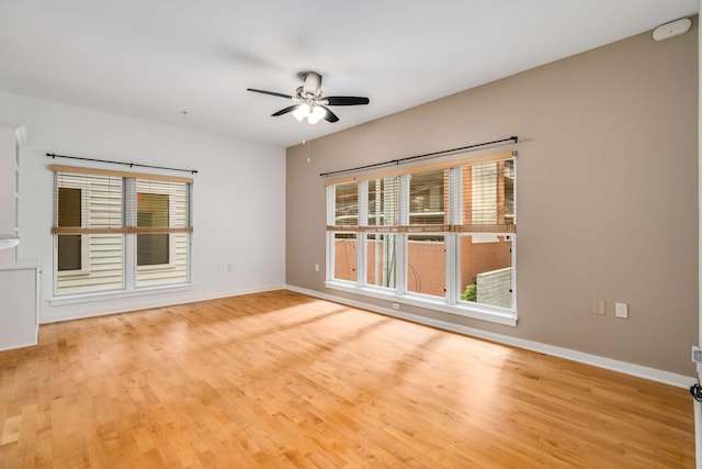 spare room with ceiling fan and light hardwood / wood-style floors