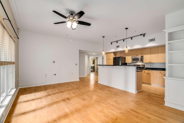 kitchen featuring pendant lighting, light hardwood / wood-style flooring, ceiling fan, light brown cabinetry, and stainless steel appliances