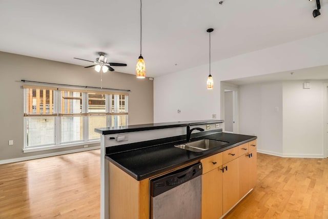 kitchen with light brown cabinetry, light wood-type flooring, stainless steel dishwasher, and sink