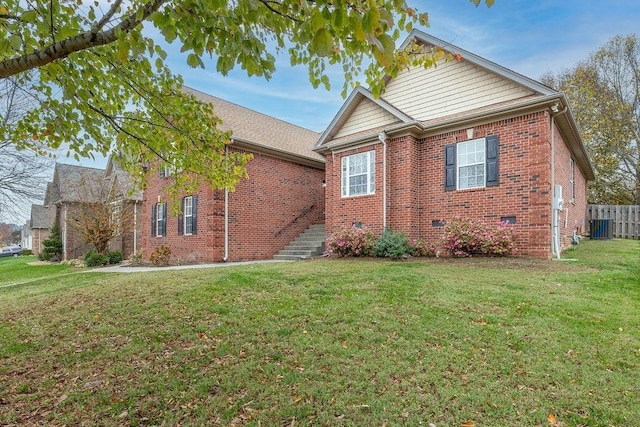 view of front of house featuring a front yard and central AC