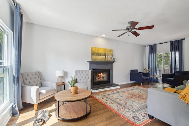 living room with hardwood / wood-style floors and ceiling fan