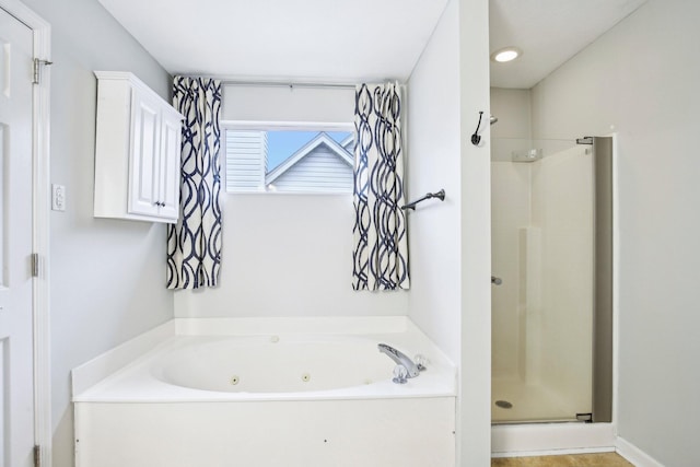 bathroom featuring shower with separate bathtub