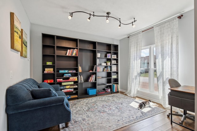 living area with plenty of natural light and wood-type flooring