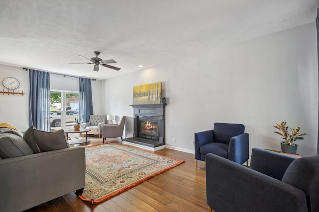 living room featuring hardwood / wood-style flooring and ceiling fan