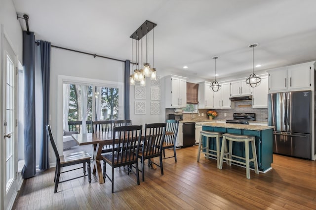 dining area with dark hardwood / wood-style flooring and sink