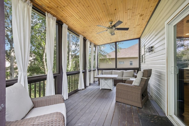 sunroom / solarium with ceiling fan, wooden ceiling, and a wealth of natural light