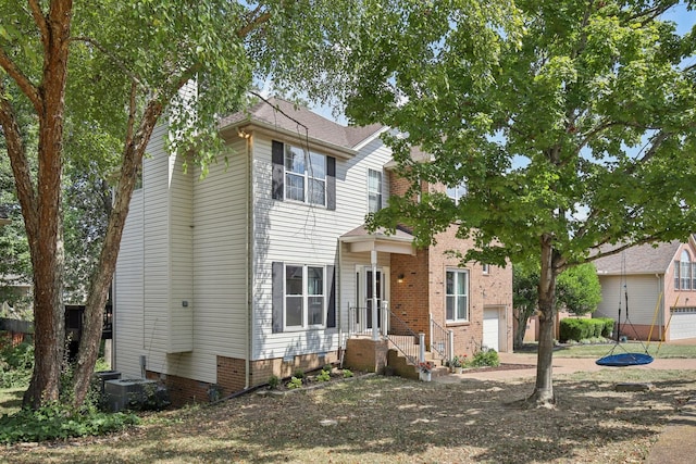 view of front of property with cooling unit and a garage