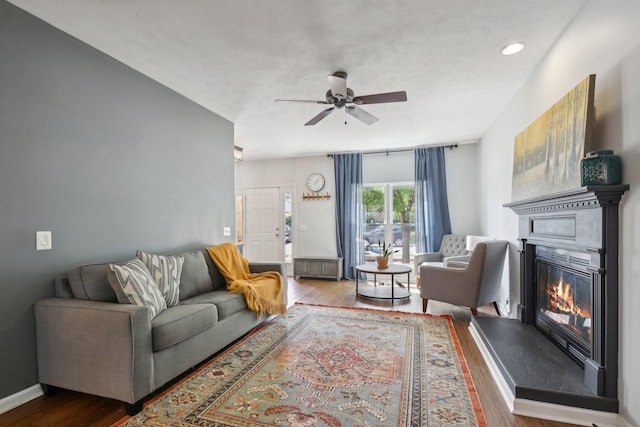 living room with ceiling fan and hardwood / wood-style floors