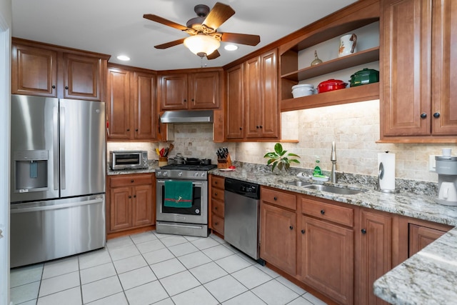 kitchen featuring sink, decorative backsplash, light tile patterned floors, appliances with stainless steel finishes, and light stone counters