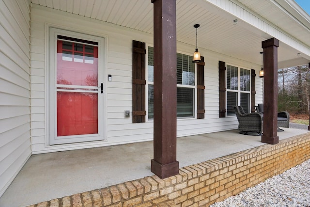 view of exterior entry with a porch