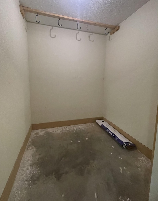 spare room featuring concrete floors and a textured ceiling