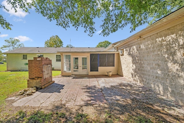 rear view of house featuring a patio area and french doors