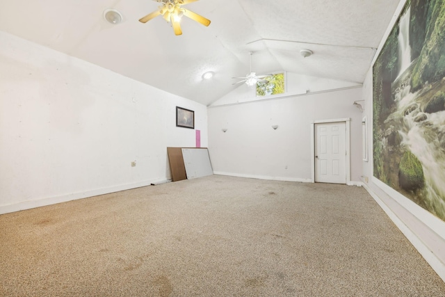 empty room featuring ceiling fan, carpet, and vaulted ceiling