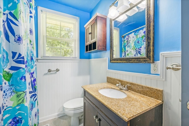 bathroom with tile patterned flooring, wood walls, toilet, vanity, and a shower with shower curtain