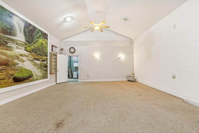 unfurnished room with ceiling fan, lofted ceiling, and a textured ceiling